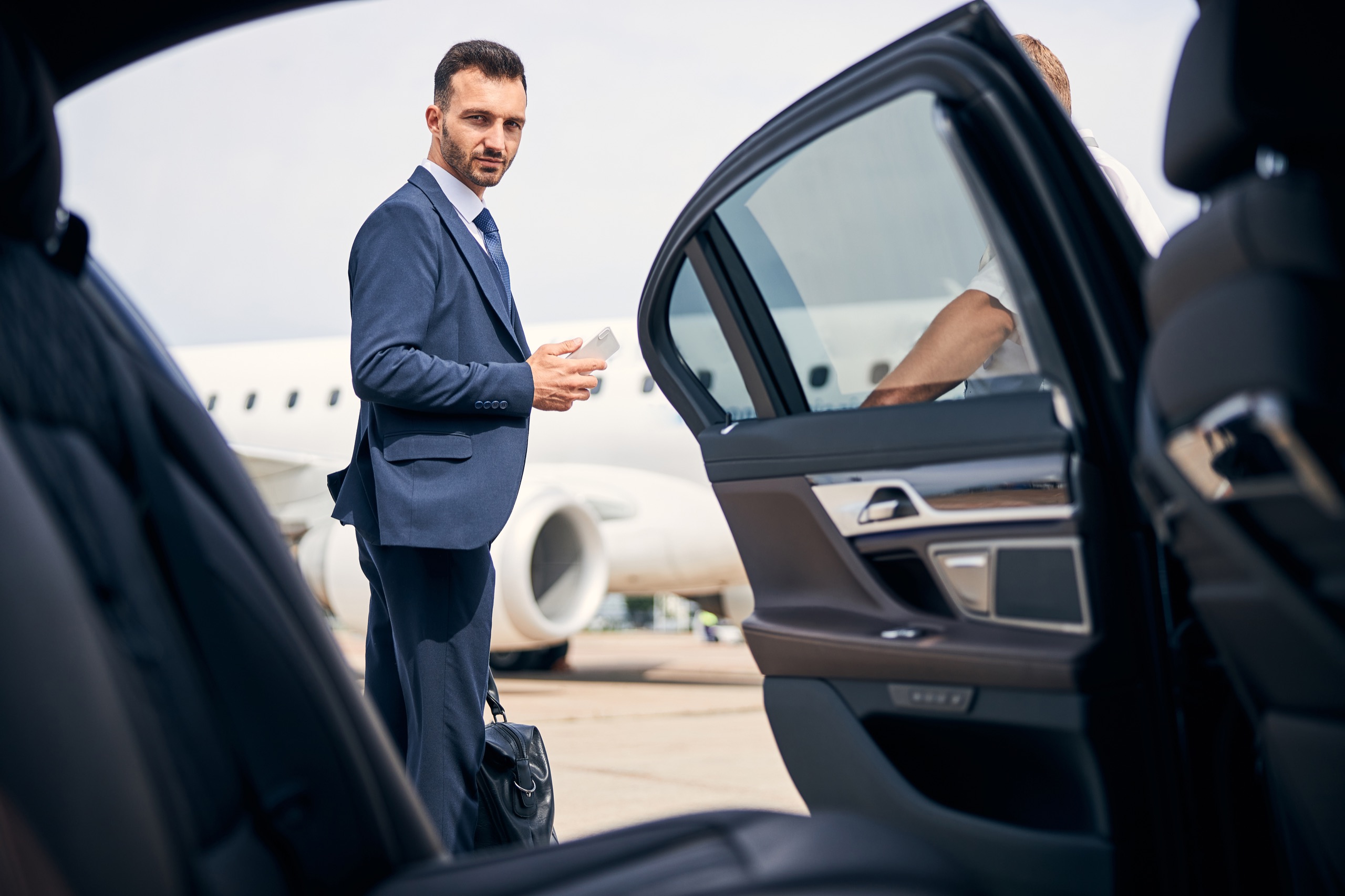 Private aviation guest approaching a waiting executive vehicle